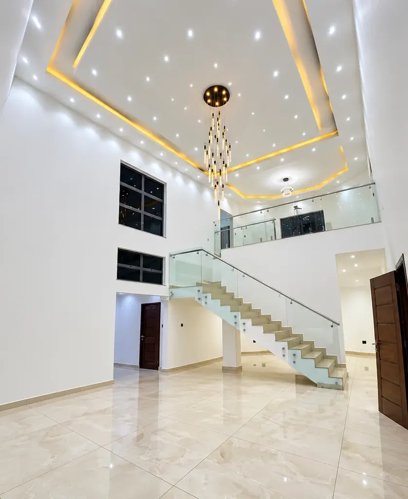 Double-height stair hall with a chandelier at Lotus by Bamboo.